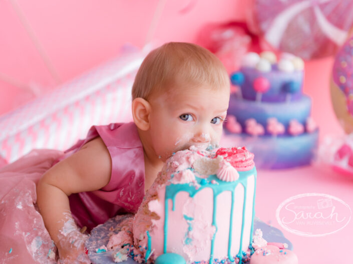 Baby bijt in taart, baby viert eerste verjaardag met taart, baby eet taart,smashcake, Sarah Van Ruyssevelt Photography, cakesmash fotografie